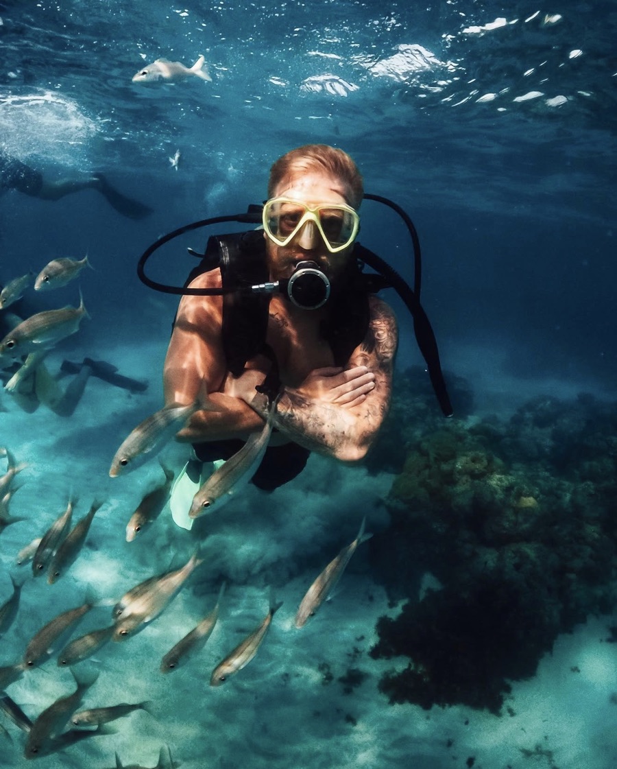 Francisco scuba diving among fish near Natal